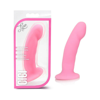 Pink silicone dildo with curved tip and suction base shown inside and outside clear pink-trimmed Luxe packaging.