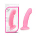 Pink silicone dildo with curved tip and suction base shown inside and outside clear pink-trimmed Luxe packaging.
