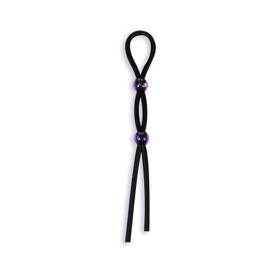 Black silicone cock tie with adjustable purple beads on a white background.