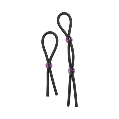 Two black silicone lasso-style cock ties with adjustable purple beads on a white background.