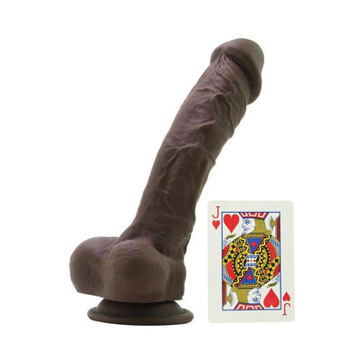 Dark brown realistic silicone dildo with suction cup base next to a playing card for size comparison.