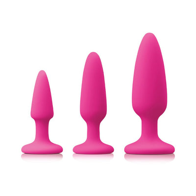 Set of three pink silicone anal trainer plugs in small, medium, and large sizes with tapered tips and flared bases.
