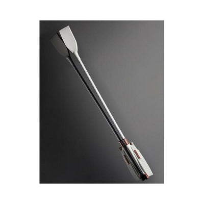 White vegan leather crop with diamond print wrist strap and metal COQUETTE charm on a dark gray background.