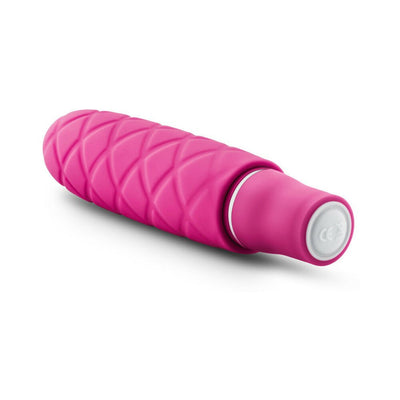 Compact pink silicone mini stimulator with textured diamond pattern and smooth satin finish.