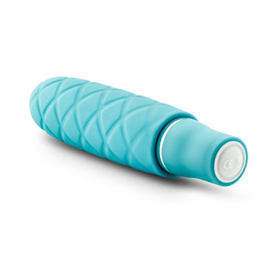 Periwinkle blue mini stimulator with textured silicone surface and smooth satin finish, compact and travel-friendly design.