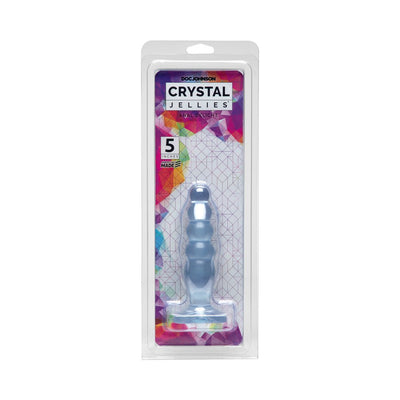 Crystal Jellies Anal Delight 5-inch graduated purple anal plug in clear retail packaging with colorful geometric background.
