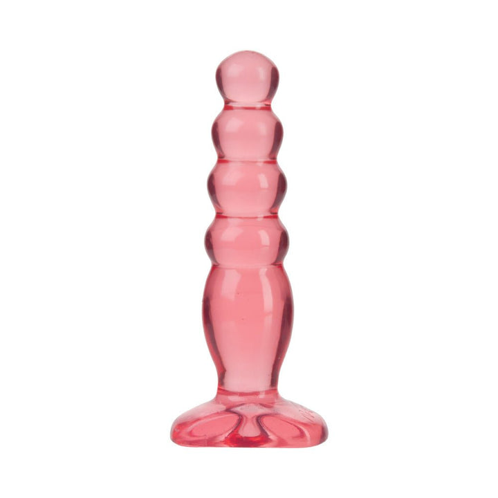 Translucent pink graduated anal plug with rounded tiers and flared base for safe, comfortable use.