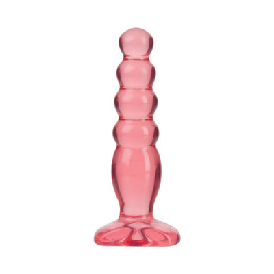 Translucent pink graduated anal plug with rounded tiers and flared base for safe, comfortable use.
