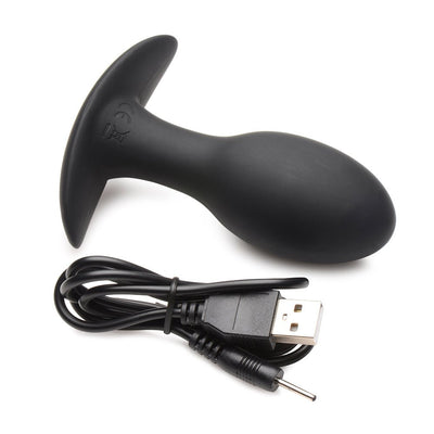 Black silicone vibrating anal plug with flared base and USB charging cable on white background.