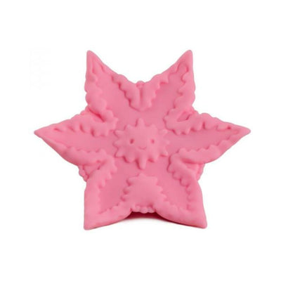 Pink star-shaped silicone vibrator with textured ridges and a small smiling sun design in the center.