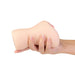Hand holding a compact, flesh-toned dual-opening stroker with realistic texture and contours.