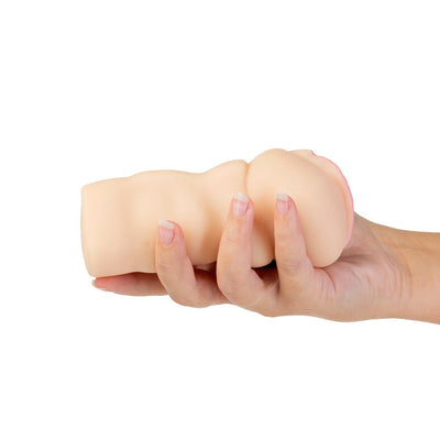 Hand holding a compact, flesh-toned lifelike stroker with textured exterior and pink inner opening on white background.