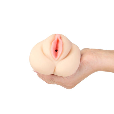 Hand holding a compact, realistic soft silicone trainer stroker with a vaginal opening and open-ended design.