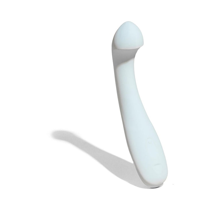 Sleek white curved pleasure tool with a rounded tip and ergonomic handle casting a shadow on a white background.