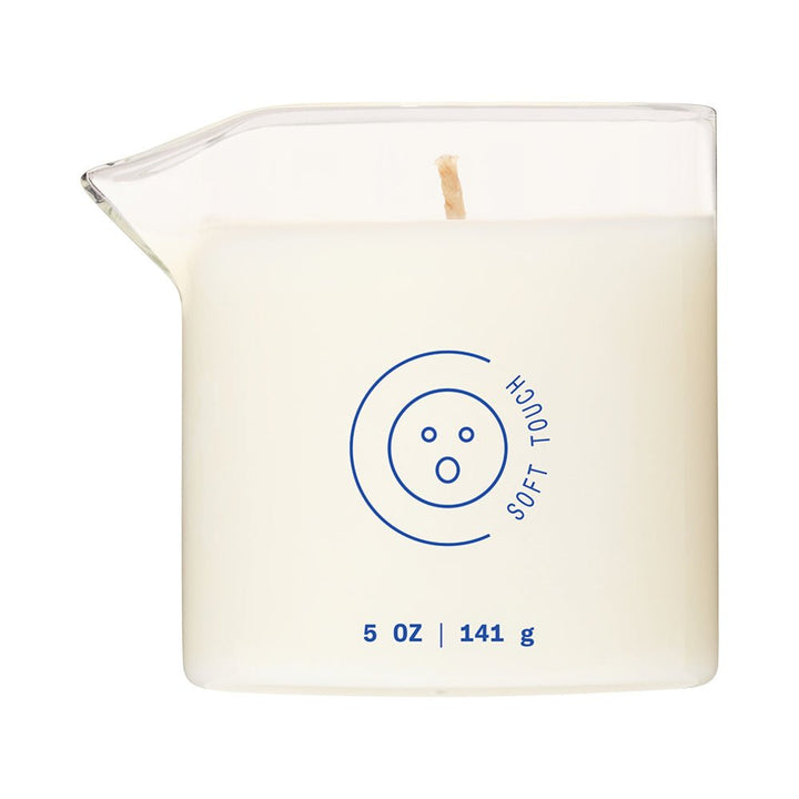 Dame Massage Oil Candle in clear glass jar with easy-pour spout and soft touch scent label.
