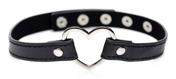 Black vegan leather choker with adjustable snap closures and a central silver-tone heart-shaped metal detail.