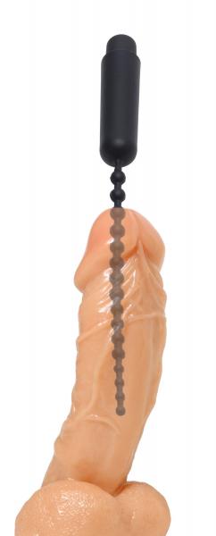 Black vibrating beaded silicone sound positioned on a realistic skin-tone model for demonstration.
