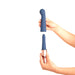 Hands holding two detachable blue silicone vibrator components, one curved and one slim, against a white background.