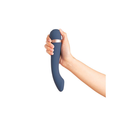 Hand holding a curved navy blue silicone massager with a rose gold accent band against a white background.
