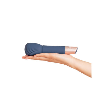 Hand holding a compact blue silicone wand massager with a rose gold accent and textured head.
