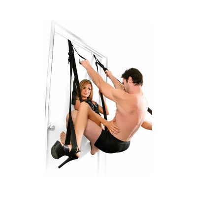 Couple using Fetish Fantasy Deluxe Door Swing with adjustable straps and cuffs on a white door.