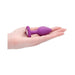 Hand holding a purple silicone butt plug with a diamond-shaped gem at the flared base.