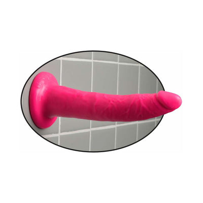 Bright pink flexible adult toy with suction cup base mounted on gray tiled wall.