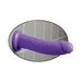 Purple Dillio dildo with suction cup base attached to tiled wall for hands-free use.