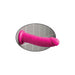 Pink Dillio dildo with suction cup base attached to tiled wall for hands-free use.