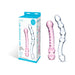 Set of two hand-blown glass dildos in pink and clear with textured designs, shown with packaging box.