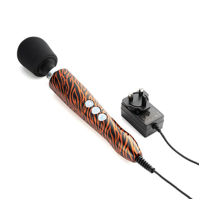 Doxy Die Cast wand massager with tiger pattern handle, black silicone head, and attached power charger on white background.