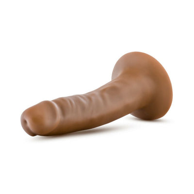 Vanilla-colored 5.5 inch realistic dildo with suction cup base lying on white background.