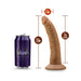 Chocolate-colored realistic dildo with suction cup base, 7 inches insertable length, shown next to a 7.5-inch soda can for size comparison.