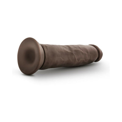 Realistic 9.5 inch vanilla-colored dildo with suction base lying on white background.