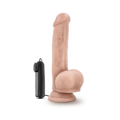 Realistic flesh-toned vibrating dildo with suction cup base and wired remote control on white background