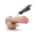 Realistic flesh-toned vibrating dildo with suction cup base and wired remote control with AA batteries visible