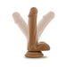 Tan realistic dildo with suction cup base shown in multiple angled positions on white background.