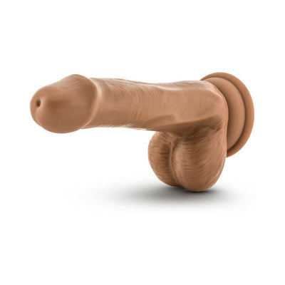 Tan realistic dildo with suction cup base and detailed texture including balls, designed for versatile use.