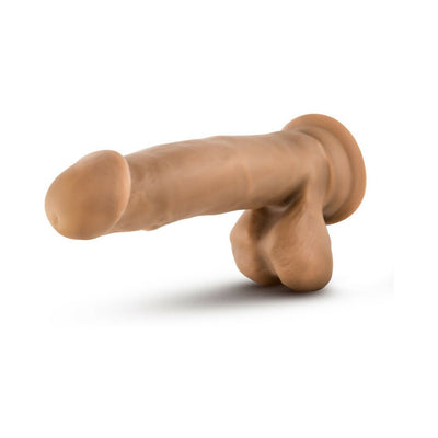 Tan realistic dildo with balls and suction cup base for hands-free use and harness compatibility.