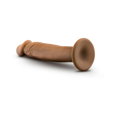 Vanilla-colored realistic 6-inch dildo with suction cup base lying on white background.