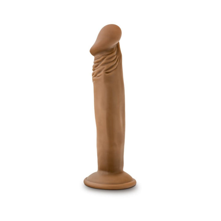 Vanilla-colored realistic 6-inch dildo with suction base standing upright on white background.