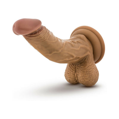 Realistic tan dildo with detailed veins and balls, featuring a strong suction cup base for hands-free use.