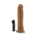 Realistic brown vibrating dildo with suction cup base and attached black remote control on white background