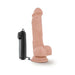 Realistic flesh-toned vibrating dildo with suction cup base and attached black remote control on white background.