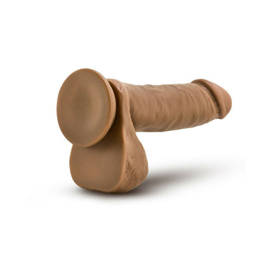 Tan realistic dildo with suction cup base and attached balls, designed for hands-free and harness play.
