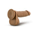 Tan realistic dildo with suction cup base and attached balls, designed for hands-free and harness play.