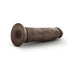 Posable 9-inch chocolate-colored dildo with textured surface and suction cup base lying on white background.