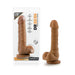 Chocolate-colored realistic dildo with suction cup base displayed next to its clear packaging.