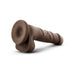 Chocolate-colored realistic dildo with suction cup base lying on a white surface.