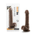 Chocolate-colored realistic dildo with suction cup base displayed next to its clear packaging.